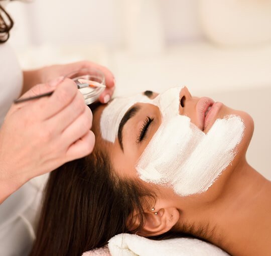 Mask facial Woman getting a luxurious facial treatment